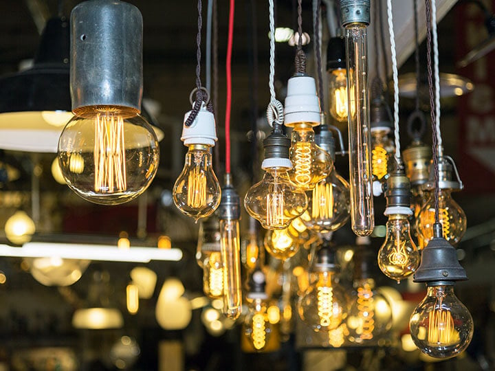 Group of different kinds of Vintage Light Bulbs with Incandescent Filament hanging from a ceiling